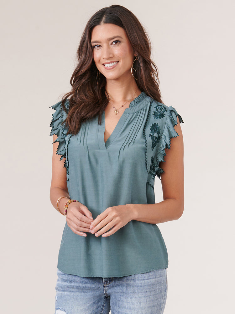 
            
                Load image into Gallery viewer, Blue Spruce Die Cut Embroidered Edge Flutter Sleeve V Placket Woven Top
            
        