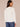 Off White Long Puff Sleeve Cinched Ruffle Edge Front Center Seam Ladder Crochet Detail Crew Neck Knit Top