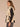 Birch Black Sleeveless Funnel Neck Zip Front Toggle Waist Ties Breast Pockets Side Entry Pockets Shirttail Hem Woven Cow Print Faux Fur Lined Vest