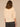Macadamia Below Elbow Blouson Sleeve Round Neck Half Button Placket Embroidered Front Pleated Back Shirttail Hem Woven Top