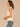 Macadamia Ruffle Cap Sleeve Ruffle Stand Collar Notch Neck Tie Back Pleat Shirttail Hem Knit Top