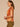 Spiced Tea Multi Short Smocked Shoulder Dolman Sleeve Smocked Embroidered Scoop Neck Placement Print Shirttail Hem Knit Top